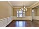 Spacious dining area with hardwood flooring, elegant lighting, and decorative wall trim at 12095 Cameron Dr, Duluth, GA 30097