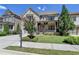 Charming two-story home with stone accents, covered porch, and well-manicured landscaping at 12095 Cameron Dr, Duluth, GA 30097