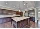 Beautiful kitchen with an island, stainless steel appliances, and dark wood cabinets at 12095 Cameron Dr, Duluth, GA 30097