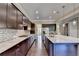 A kitchen featuring granite counters, stainless steel appliances, and dark wood cabinets at 12095 Cameron Dr, Duluth, GA 30097