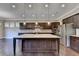 Open-concept kitchen featuring a large island, stainless steel appliances, and great lighting at 12095 Cameron Dr, Duluth, GA 30097