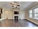 Living room with dark hardwood floors, fireplace, and television at 12095 Cameron Dr, Duluth, GA 30097