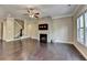 Living room with hardwood floors, fireplace, and staircase at 12095 Cameron Dr, Duluth, GA 30097