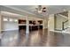 Spacious living room seamlessly connects kitchen and staircase, with rich hardwood floors at 12095 Cameron Dr, Duluth, GA 30097