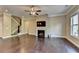 Cozy living room features dark hardwood floors, fireplace with television, and staircase at 12095 Cameron Dr, Duluth, GA 30097