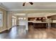 Open-concept living room flows to a modern kitchen with dark cabinets and hardwood floors at 12095 Cameron Dr, Duluth, GA 30097