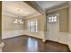 Bright living room featuring hardwood floors, wainscoting, and large windows that offer plenty of natural light at 12095 Cameron Dr, Duluth, GA 30097