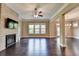 Spacious living room features a brick fireplace, hardwood floors, and natural light at 12095 Cameron Dr, Duluth, GA 30097
