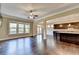 Bright living room features hardwood floors, large windows, and an open floor plan to the kitchen at 12095 Cameron Dr, Duluth, GA 30097