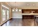 Dining room with dark hardwood floors and French doors leading to an outdoor deck near kitchen at 12095 Cameron Dr, Duluth, GA 30097