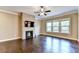 Living room with brick fireplace, hardwood floors, and large windows at 12095 Cameron Dr, Duluth, GA 30097