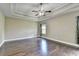 Spacious main bedroom featuring a trey ceiling, hardwood floors, and a window for natural light at 12095 Cameron Dr, Duluth, GA 30097