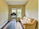 Cozy room with treadmill, rug, and a leather couch; potential for an office or workout area at 12095 Cameron Dr, Duluth, GA 30097