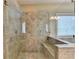 Close-up of tiled shower with glass door and built-in bench seating at 12095 Cameron Dr, Duluth, GA 30097