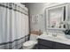 This bathroom has a shower-tub combo, a single sink vanity, and a large framed mirror at 1667 Wehunt Se Pl # 11, Smyrna, GA 30082