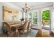 Cozy dining area with a modern chandelier and a view of the outdoor deck, perfect for intimate meals and gatherings at 1667 Wehunt Se Pl # 11, Smyrna, GA 30082