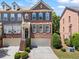 Charming brick townhome with a two-car garage and inviting front entrance with dark shutters and trim at 1667 Wehunt Se Pl # 11, Smyrna, GA 30082