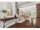 Inviting foyer featuring hardwood floors, an elegant console table, and access to the dining room and staircase at 1667 Wehunt Se Pl # 11, Smyrna, GA 30082