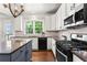 Bright and updated kitchen with stainless steel appliances, white cabinetry, and a view of the backyard at 1667 Wehunt Se Pl # 11, Smyrna, GA 30082