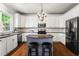 Modern kitchen with white cabinets, stainless steel appliances, granite countertops, and a center island with seating at 1667 Wehunt Se Pl # 11, Smyrna, GA 30082
