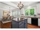 Bright eat-in kitchen with granite countertops, island, stainless steel appliances, and hardwood floors at 1667 Wehunt Se Pl # 11, Smyrna, GA 30082
