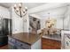Charming kitchen featuring stainless steel appliances, gray cabinets and hardwood floors adjacent to dining area at 1667 Wehunt Se Pl # 11, Smyrna, GA 30082