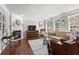 Bright living room with a fireplace, hardwood floors, and stylish decor, offering a comfortable and inviting space at 1667 Wehunt Se Pl # 11, Smyrna, GA 30082