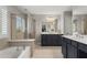 Spacious primary bathroom with double vanities, soaking tub, and glass-enclosed shower at 1667 Wehunt Se Pl # 11, Smyrna, GA 30082