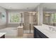 Elegant primary bathroom with walk-in shower, soaking tub, and large vanity at 1667 Wehunt Se Pl # 11, Smyrna, GA 30082