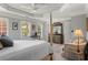 Bright main bedroom featuring tray ceilings, plantation shutters, and a comfortable seating area at 1667 Wehunt Se Pl # 11, Smyrna, GA 30082