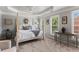 This spacious main bedroom boasts tray ceilings and natural light from multiple windows at 1667 Wehunt Se Pl # 11, Smyrna, GA 30082