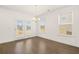 Dining room features hardwood floors, chandelier, and large windows at 1841 Lacebark Elm Way, Lawrenceville, GA 30045