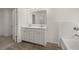 Bathroom with double sink vanity, modern fixtures, a large mirror and tile floor at 1871 Lacebark Elm Way Way, Lawrenceville, GA 30045