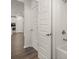 Bathroom and hallway feature hardwood floors and neutral paint tones at 1871 Lacebark Elm Way Way, Lawrenceville, GA 30045