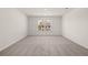 Spacious bedroom with neutral walls, plush carpeting, and a large window offering ample natural light at 1871 Lacebark Elm Way Way, Lawrenceville, GA 30045