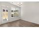 Bright dining room with natural light, modern lighting fixture and hardwood floors at 1871 Lacebark Elm Way Way, Lawrenceville, GA 30045