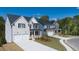 Beautifully landscaped homes featuring manicured lawns and inviting front porches at 1871 Lacebark Elm Way Way, Lawrenceville, GA 30045