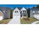 Charming two-story home featuring a two-car garage and a welcoming front porch at 1871 Lacebark Elm Way Way, Lawrenceville, GA 30045