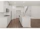 A bright, open-concept kitchen with white cabinets, stainless steel appliances, and luxury vinyl plank flooring at 1871 Lacebark Elm Way Way, Lawrenceville, GA 30045