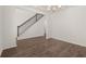 Living room with luxury vinyl plank flooring adjacent to a staircase with wood handrails and iron balusters at 1871 Lacebark Elm Way Way, Lawrenceville, GA 30045