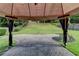 This backyard boasts a brick patio and a well-manicured lawn, and it is surrounded by trees at 2678 Adair Trl, Dacula, GA 30019