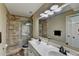 Bathroom featuring dual sinks, stone tile shower, and modern fixtures at 2678 Adair Trl, Dacula, GA 30019