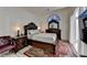 This bedroom is furnished with elegant dark wood furniture and a colorful rug at 2678 Adair Trl, Dacula, GA 30019