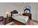 Ornate primary bedroom featuring decorative headboard, nightstands, and a dresser at 2678 Adair Trl, Dacula, GA 30019