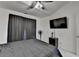 This bedroom has a ceiling fan and a TV on the wall, giving it an entertainment feel at 2678 Adair Trl, Dacula, GA 30019