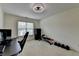Carpeted bedroom featuring a ceiling fan, natural light, and space for work and workout at 2678 Adair Trl, Dacula, GA 30019