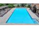 Large community swimming pool with lounge chairs and clear blue water at 2678 Adair Trl, Dacula, GA 30019