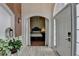Charming foyer showcasing an arched doorway, view of a bedroom, light-colored wood-look floors, and a stylish lantern at 2678 Adair Trl, Dacula, GA 30019