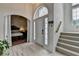 Bright entryway with a high ceiling, a staircase, and an arched doorway leading to a bedroom at 2678 Adair Trl, Dacula, GA 30019