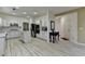 Modern kitchen with white cabinets, stainless steel appliances, a kitchen island, and light-colored wood-look floors at 2678 Adair Trl, Dacula, GA 30019